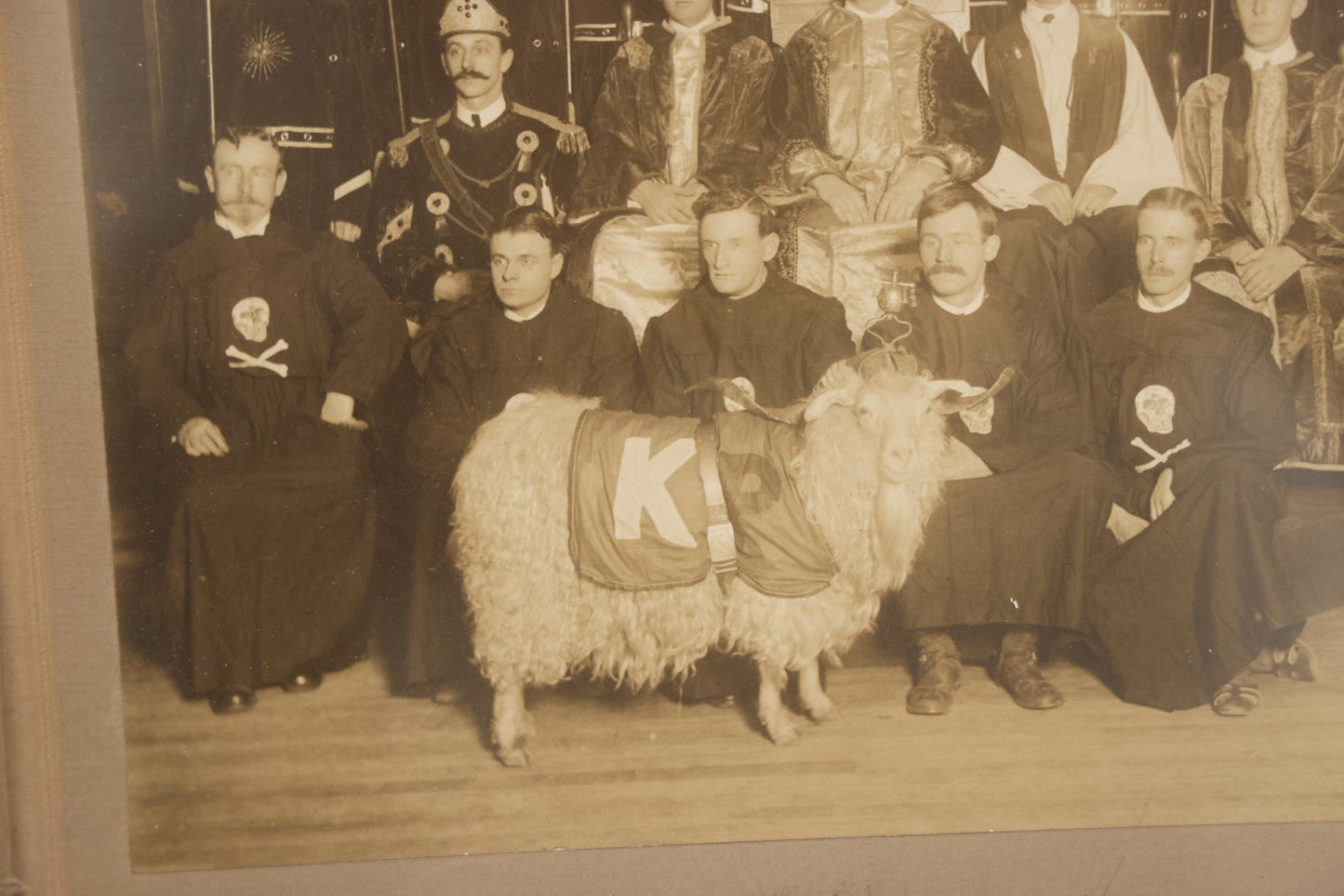 Lot 020 - Antique Boarded Group Photo, Fraternal Gathering, Likely Knights Of Pythias, With Goat And Skull And Crossbones Scene Bearers Robes, In Frame, 11-1/4" x 9-1/4"