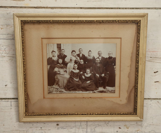 Lot 031 - Antique Late 19th Century Group Photo Of Well Dressed People, Four Men, Eight Women, Boarded And Framed, Note Water Damage To Mat