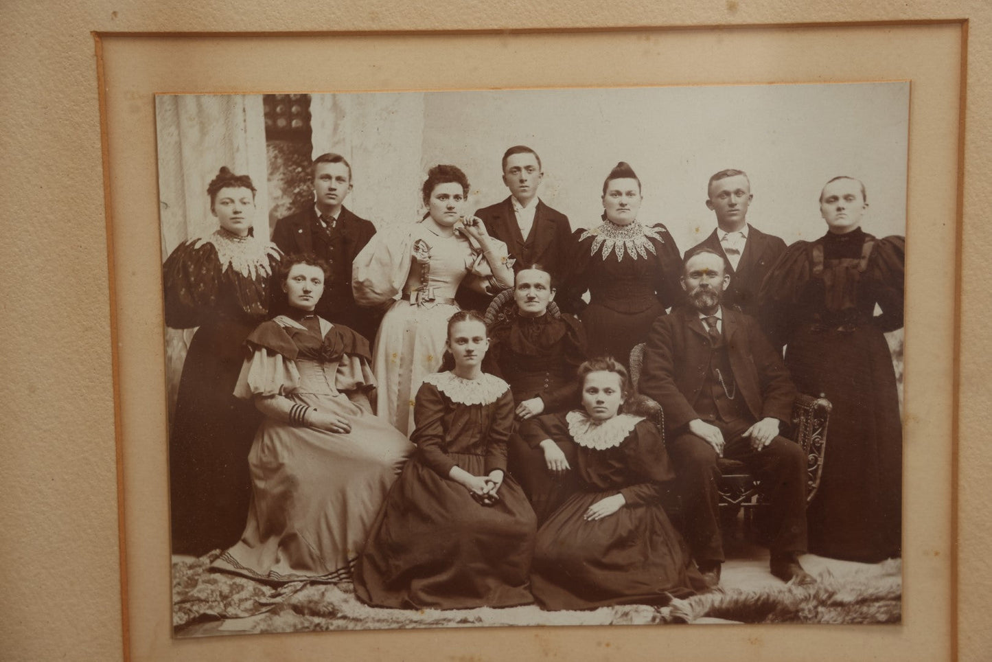 Lot 031 - Antique Late 19th Century Group Photo Of Well Dressed People, Four Men, Eight Women, Boarded And Framed, Note Water Damage To Mat