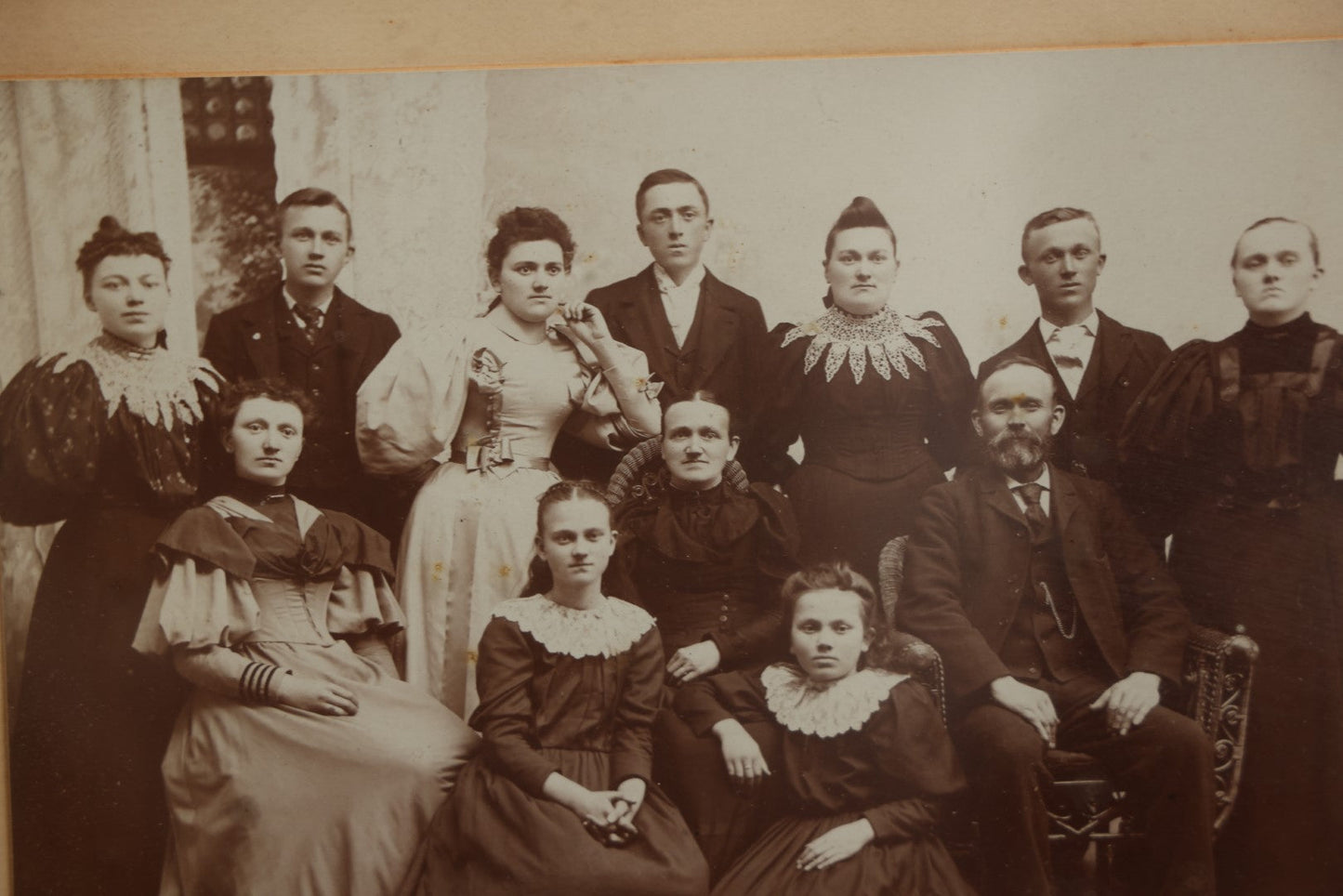 Lot 031 - Antique Late 19th Century Group Photo Of Well Dressed People, Four Men, Eight Women, Boarded And Framed, Note Water Damage To Mat