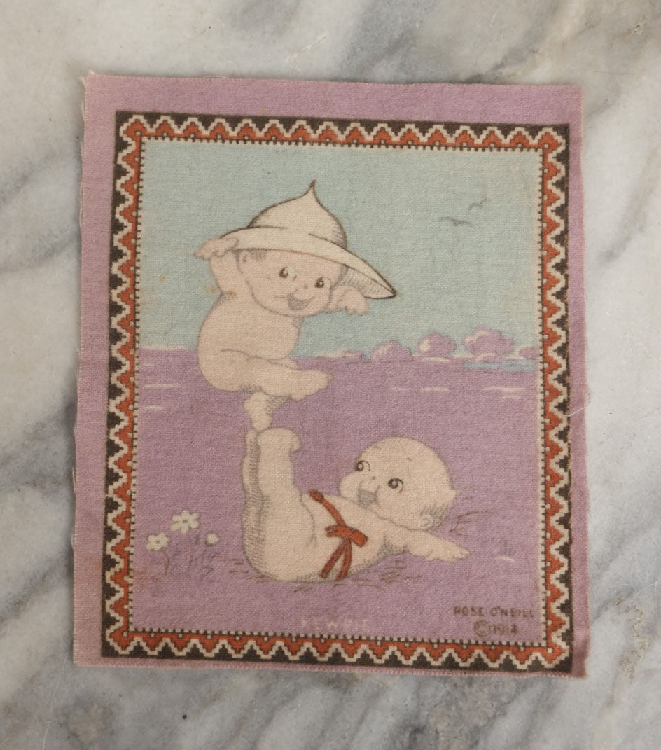 Lot 044 - Antique Original Rose O'Neill Kewpie Doll Tobacco Felt Rug, Dated 1914, Kewpie Balancing On Kewpie's Feet