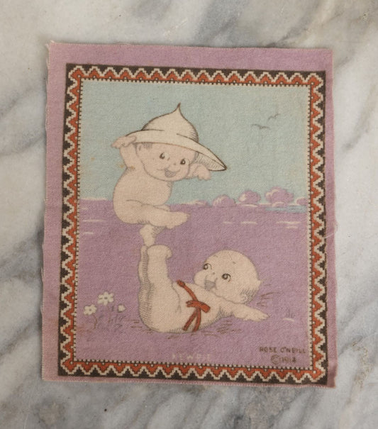 Lot 044 - Antique Original Rose O'Neill Kewpie Doll Tobacco Felt Rug, Dated 1914, Kewpie Balancing On Kewpie's Feet