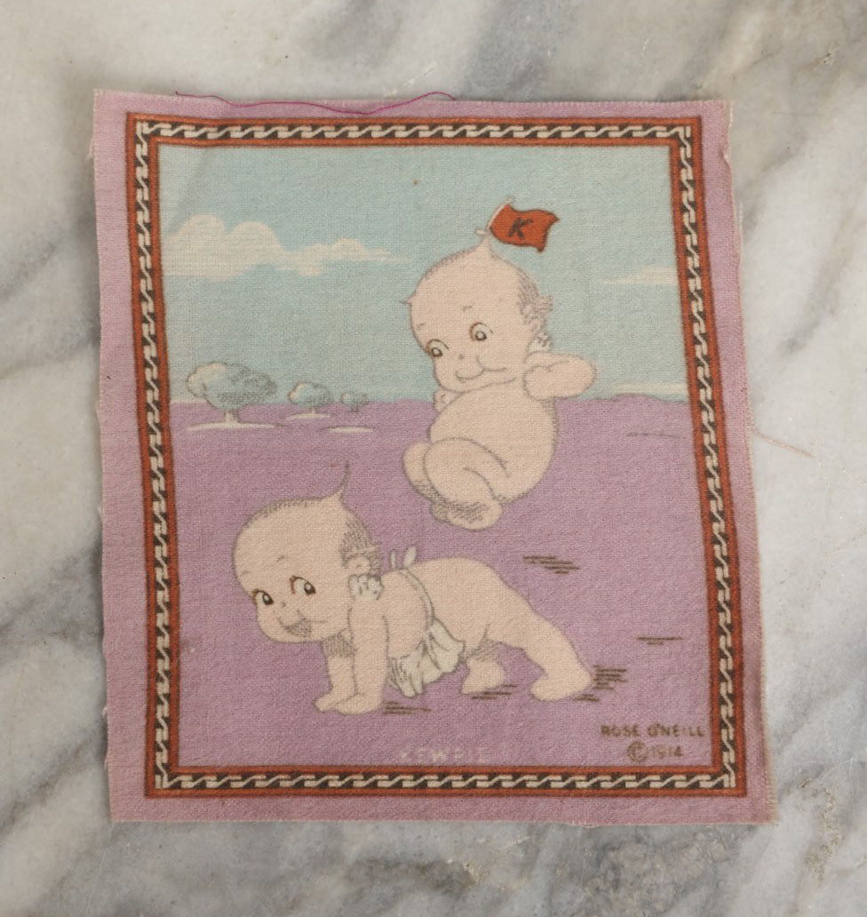 Lot 045 - Antique Original Rose O'Neill Kewpie Doll Tobacco Felt Rug, Dated 1914, Kewpie Jumping Over Kewpie