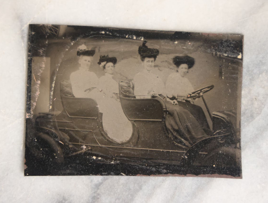 Lot 062 - Grouping Of Five Antique Tintype Photographs Of Men And Women Behind The Wheel Of Early Automobiles, Cars