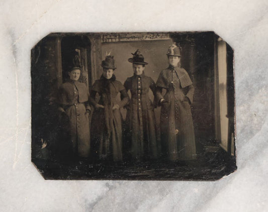 Lot 070 - Single Antique Tintype Photograph Of Four Handsomely Dressed Women In Long Coats, Landscape Orientation, Full Bodies In Shot