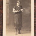 Lot 062 - Antique Real Photo Postcard R.P.P.C. Of A Young Woman In Glasses Playing A Ukulele, Possible Name Written On Back, Cora