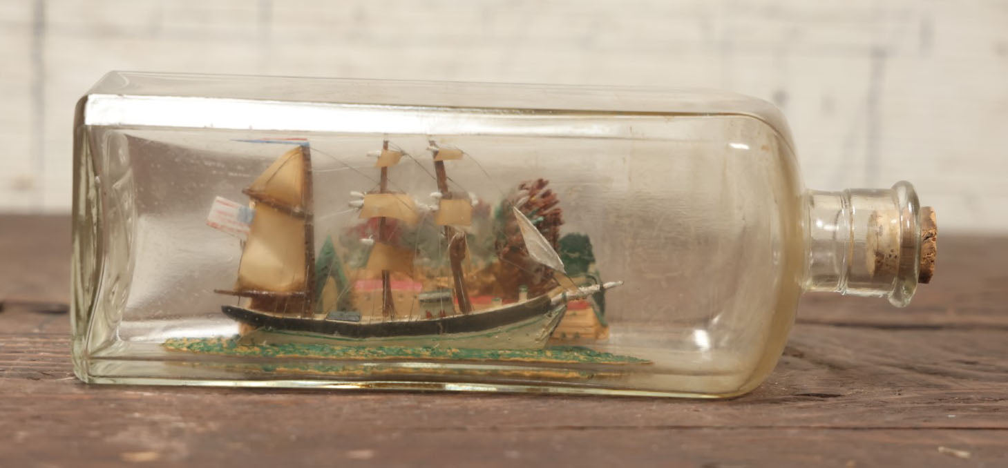 Lot 006 - Vintage Folk Art Ship In A Bottle, Handcrafted With Backdrop, Ship Has American Flag, Circa 1930