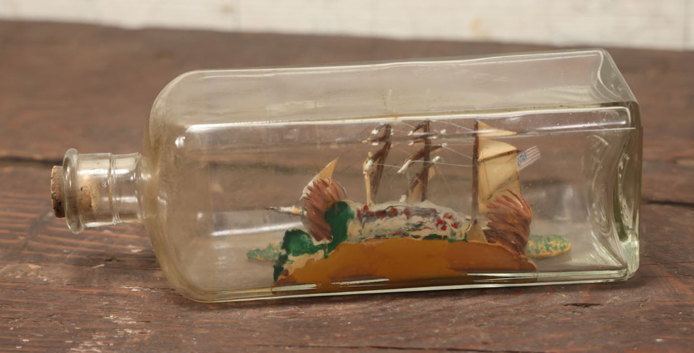 Lot 006 - Vintage Folk Art Ship In A Bottle, Handcrafted With Backdrop, Ship Has American Flag, Circa 1930