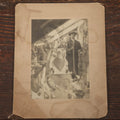 Lot 014 - Antique Boarded Photo Of A Hunter With A Rifle In A Taxidermy Shot, Posing With Buck, Other Mounts Visible Including Beaver, Owl, Etc