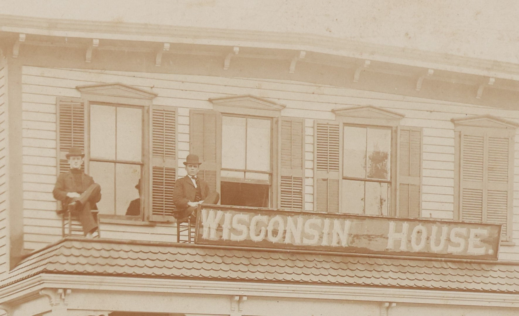 Lot 063 - Antique Boarded Photograph Of Wisconsin House, Possible Inn, With Many Men, Women, And Children On Porch, On Roof