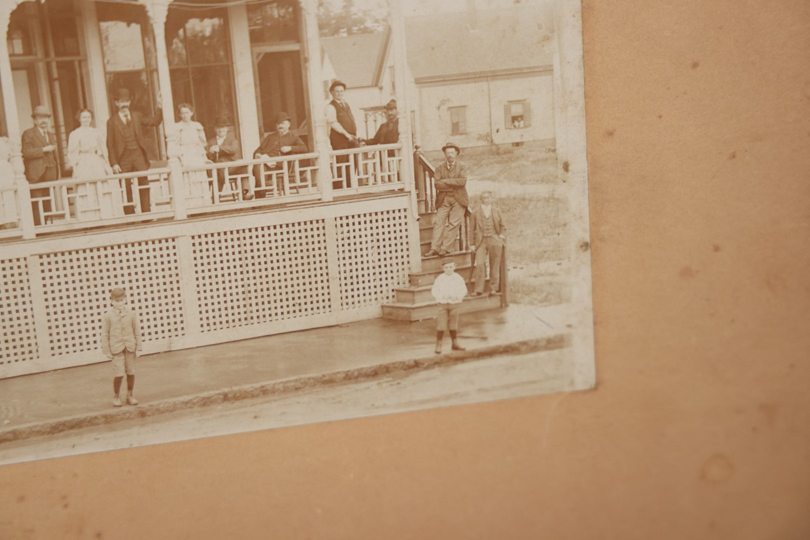 Lot 063 - Antique Boarded Photograph Of Wisconsin House, Possible Inn, With Many Men, Women, And Children On Porch, On Roof