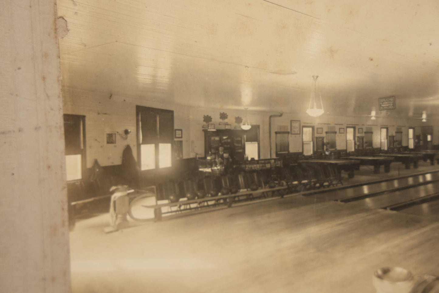 Lot 068 - Antique Boarded Occupational Photograph Of An Old Time Bowling Alley, With Man Behind Counter, Signage