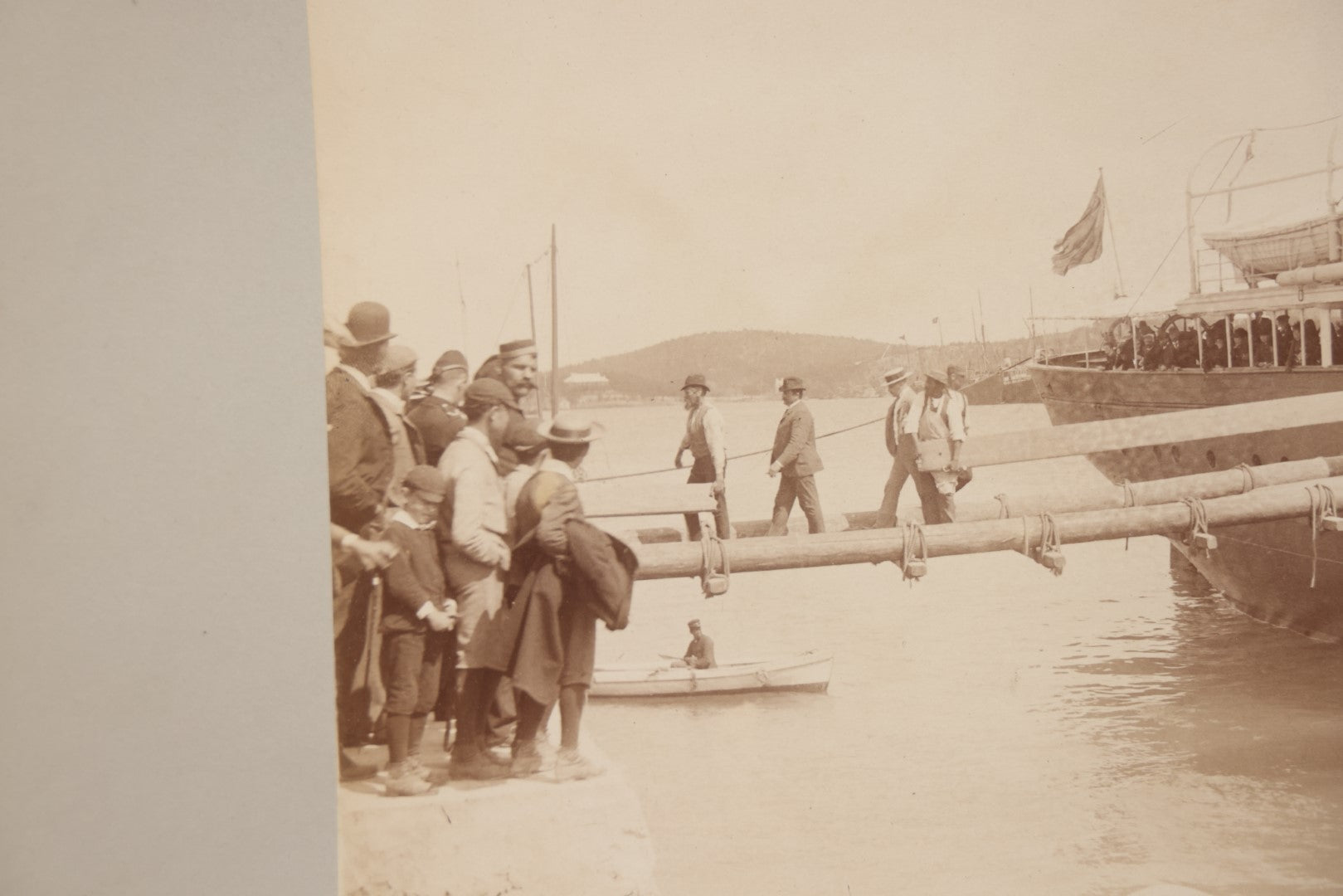 Lot 070 - Antique Boarded Photograph Of A Ship At Port, Bermuda, With Passengers And Workers Visible