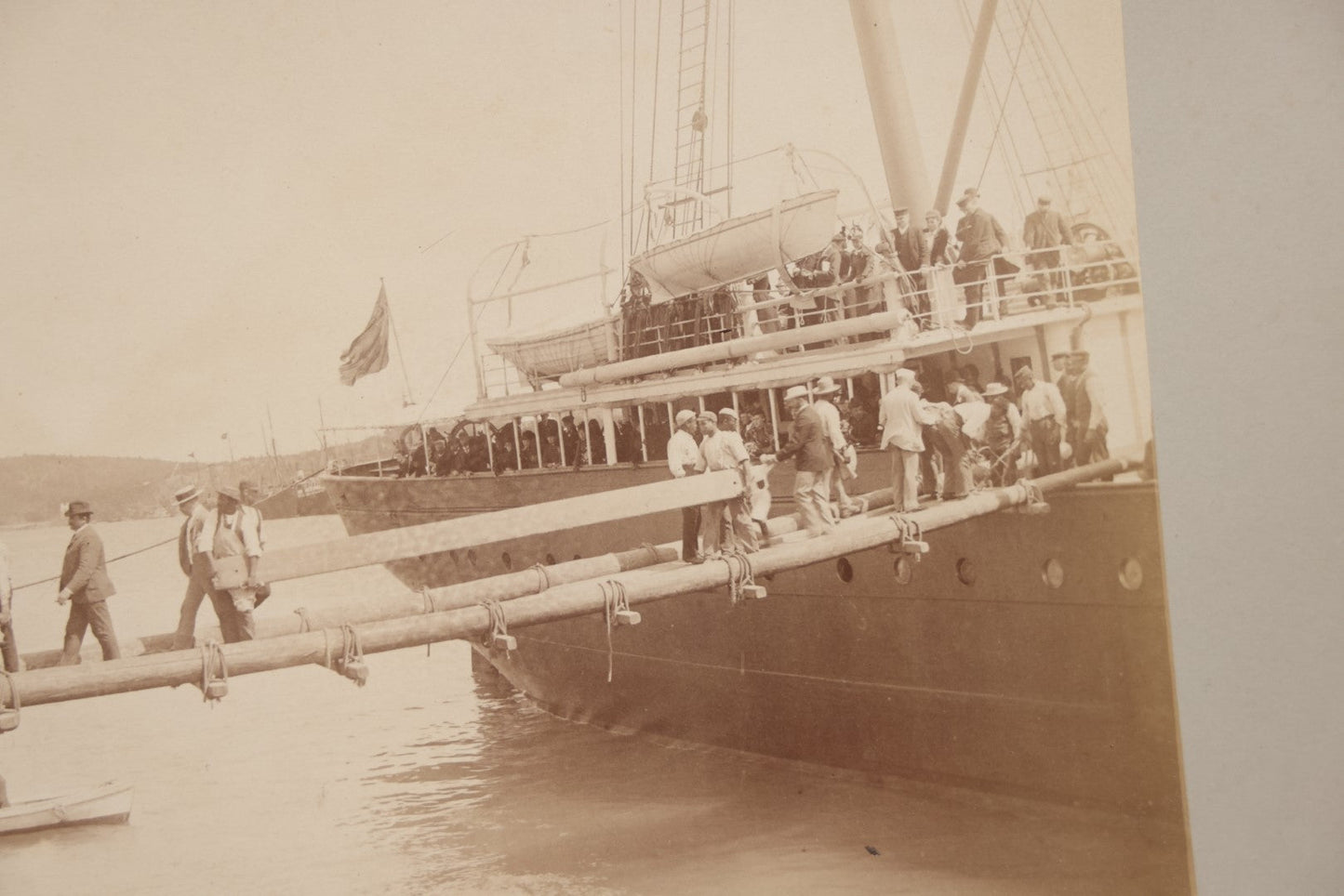 Lot 070 - Antique Boarded Photograph Of A Ship At Port, Bermuda, With Passengers And Workers Visible