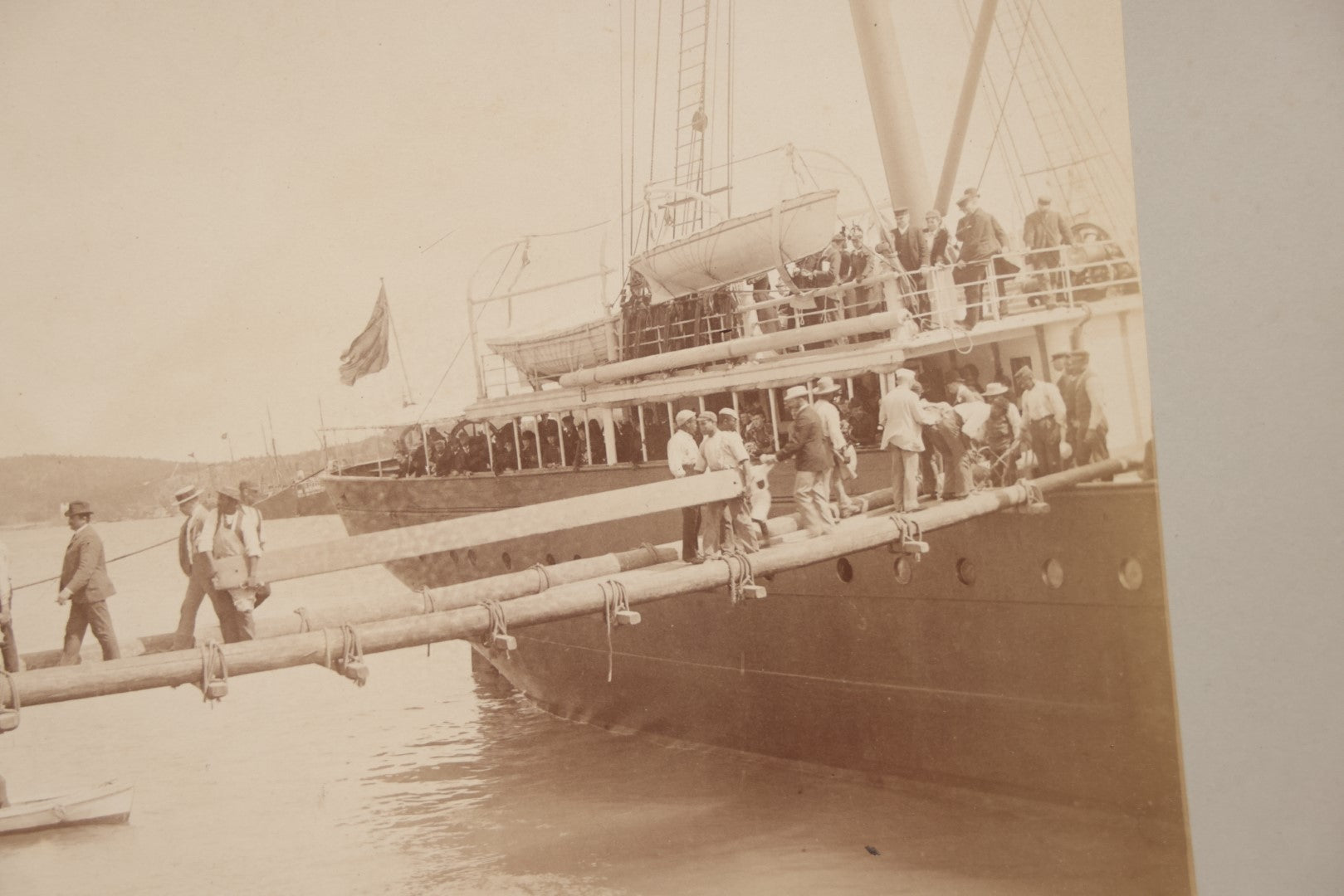 Lot 070 - Antique Boarded Photograph Of A Ship At Port, Bermuda, With Passengers And Workers Visible