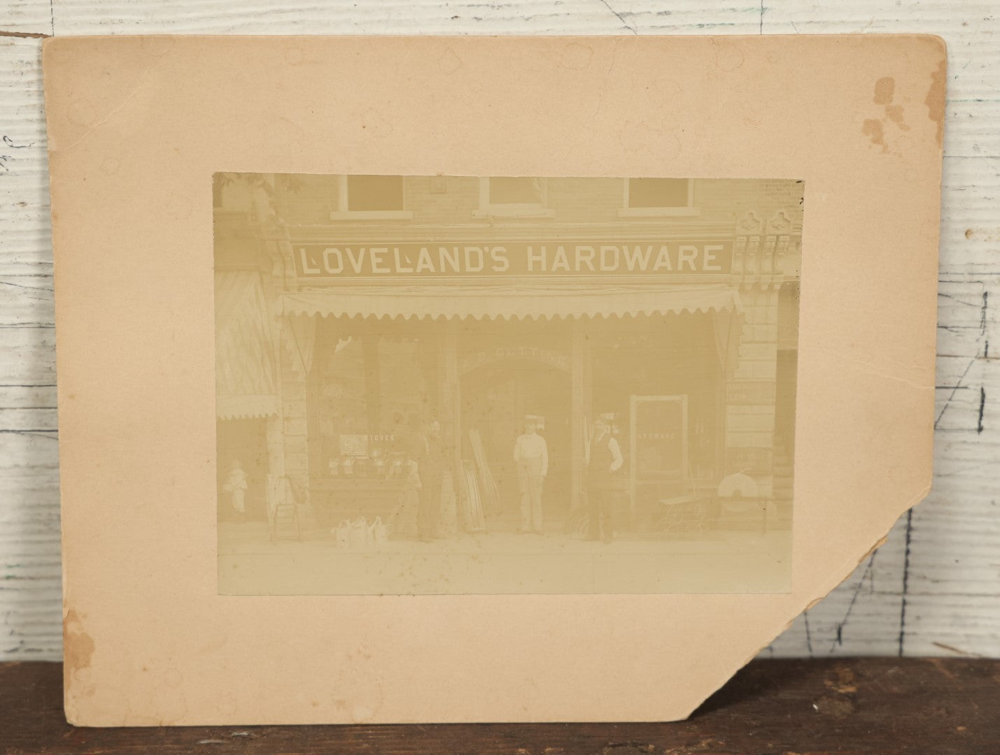 Lot 133 - Antique Boarded Occupational Photo Of Loveland's Hardware Store, Another Sign Reads A.B. Cutting, Stoves, Etc., Ogdensburg, New York, Note Loss To Board