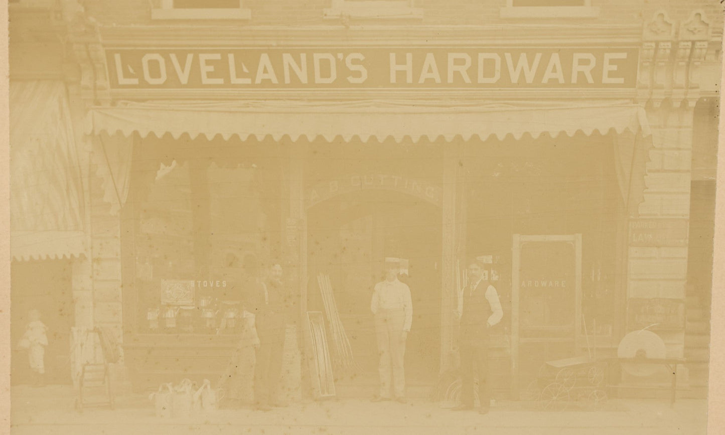 Lot 133 - Antique Boarded Occupational Photo Of Loveland's Hardware Store, Another Sign Reads A.B. Cutting, Stoves, Etc., Ogdensburg, New York, Note Loss To Board