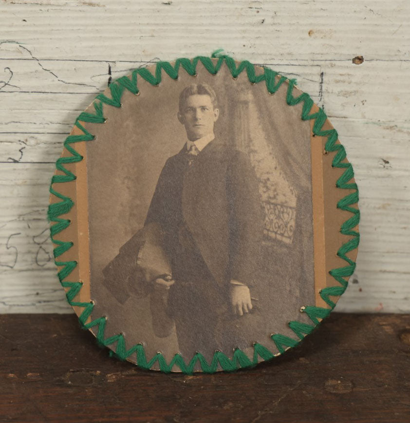 Lot 136 - Antique Circle Boarded Photo Of A Handsome Young Man With Folk Art String Design Around The Outside Edge With Green Thread