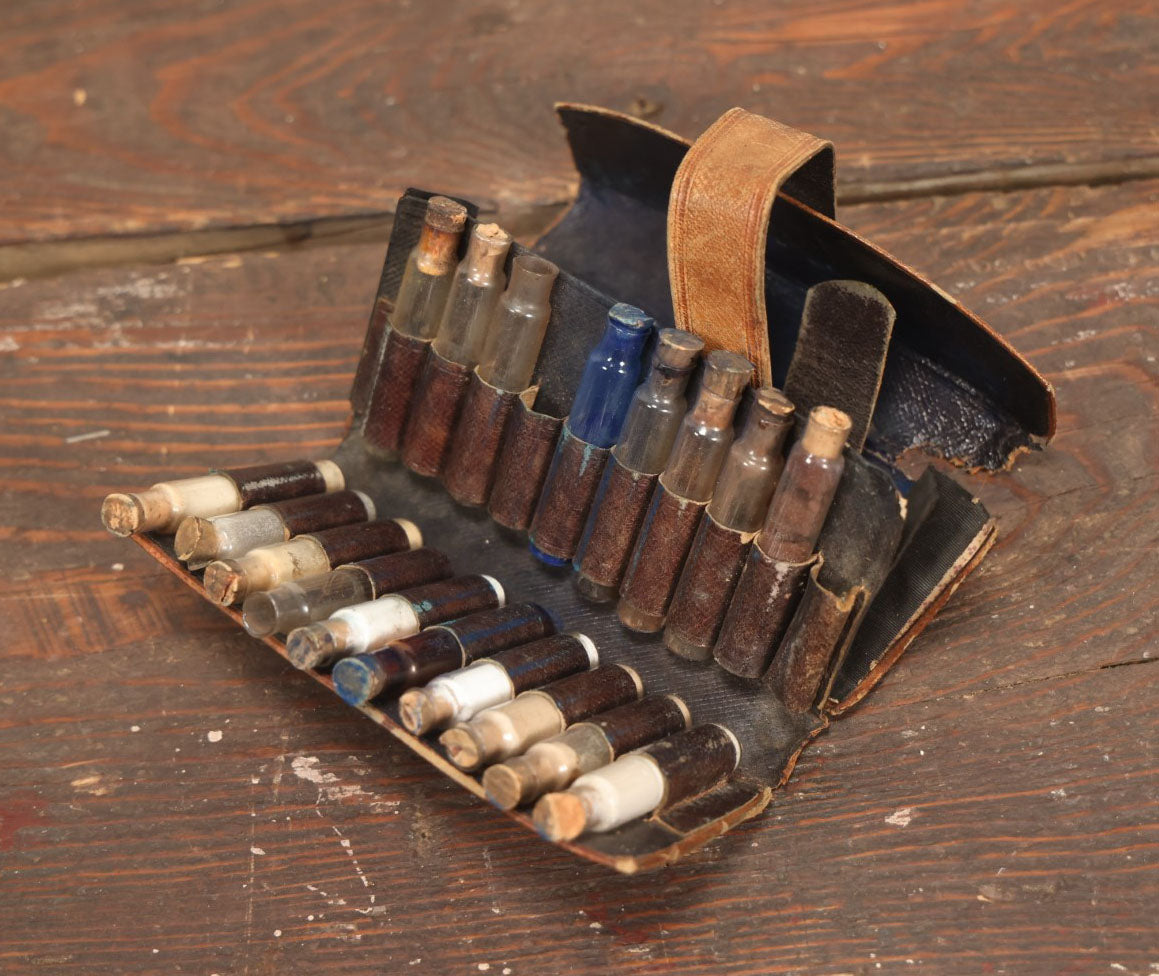 Lot 024 - Antique Leather Traveling Apothecary Wallet Kit With Many Glass Vials With Contents, Wear And Losses To Leather