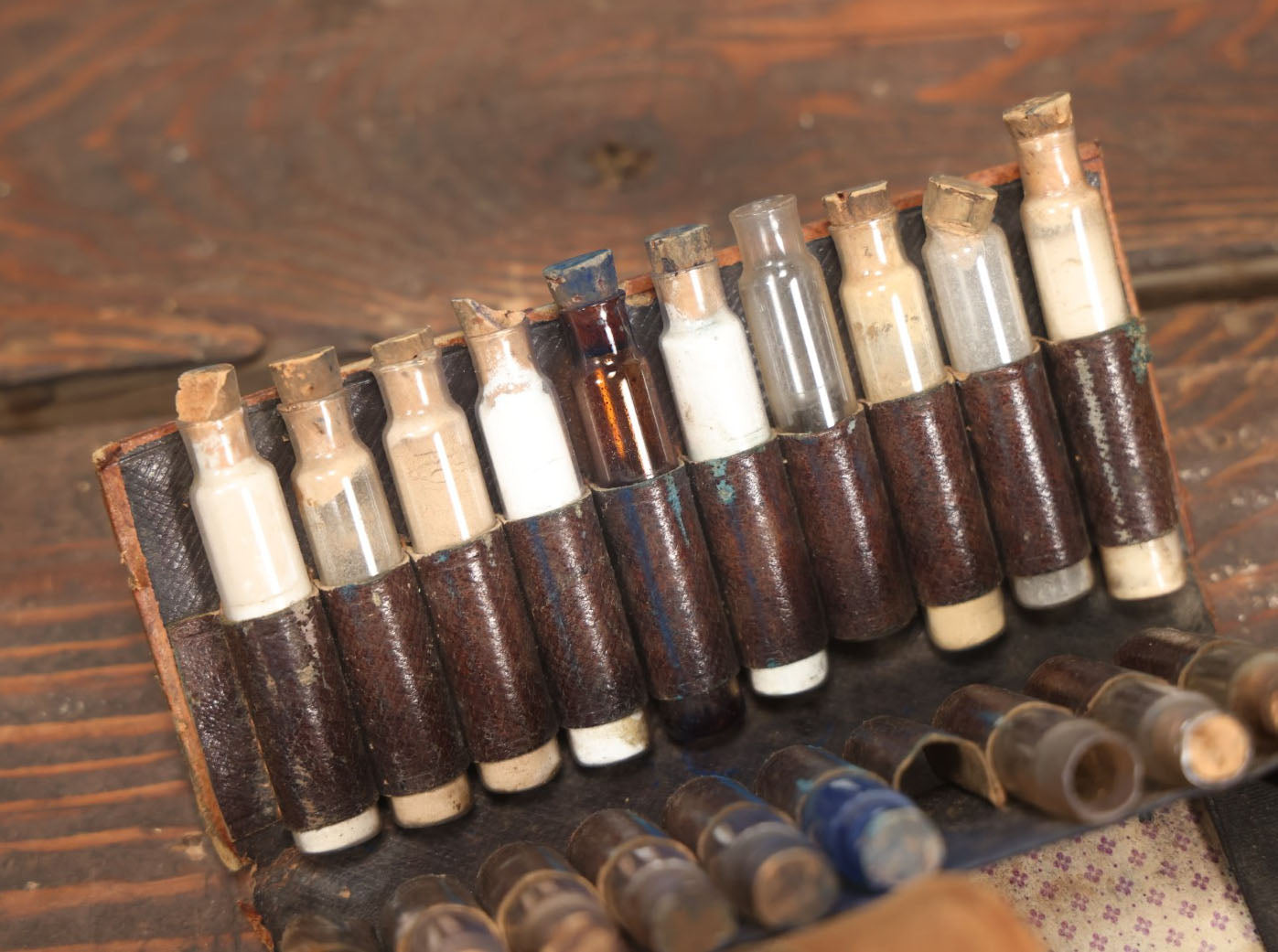 Lot 024 - Antique Leather Traveling Apothecary Wallet Kit With Many Glass Vials With Contents, Wear And Losses To Leather