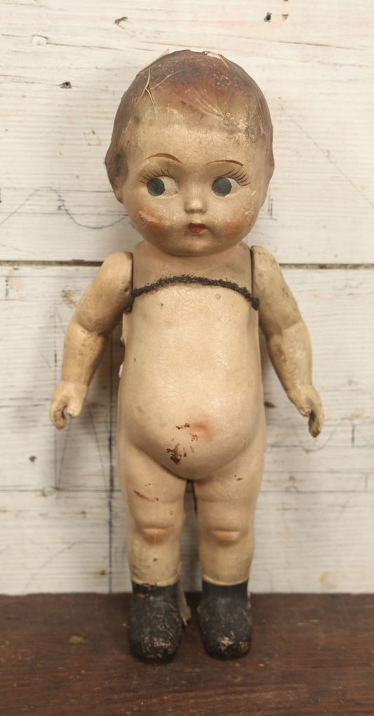 Lot 038 - Antique Composition Kewpie Like Doll With Cute Face, Painted Details, 14" Tall, Various Wear And Loss To Porcelain