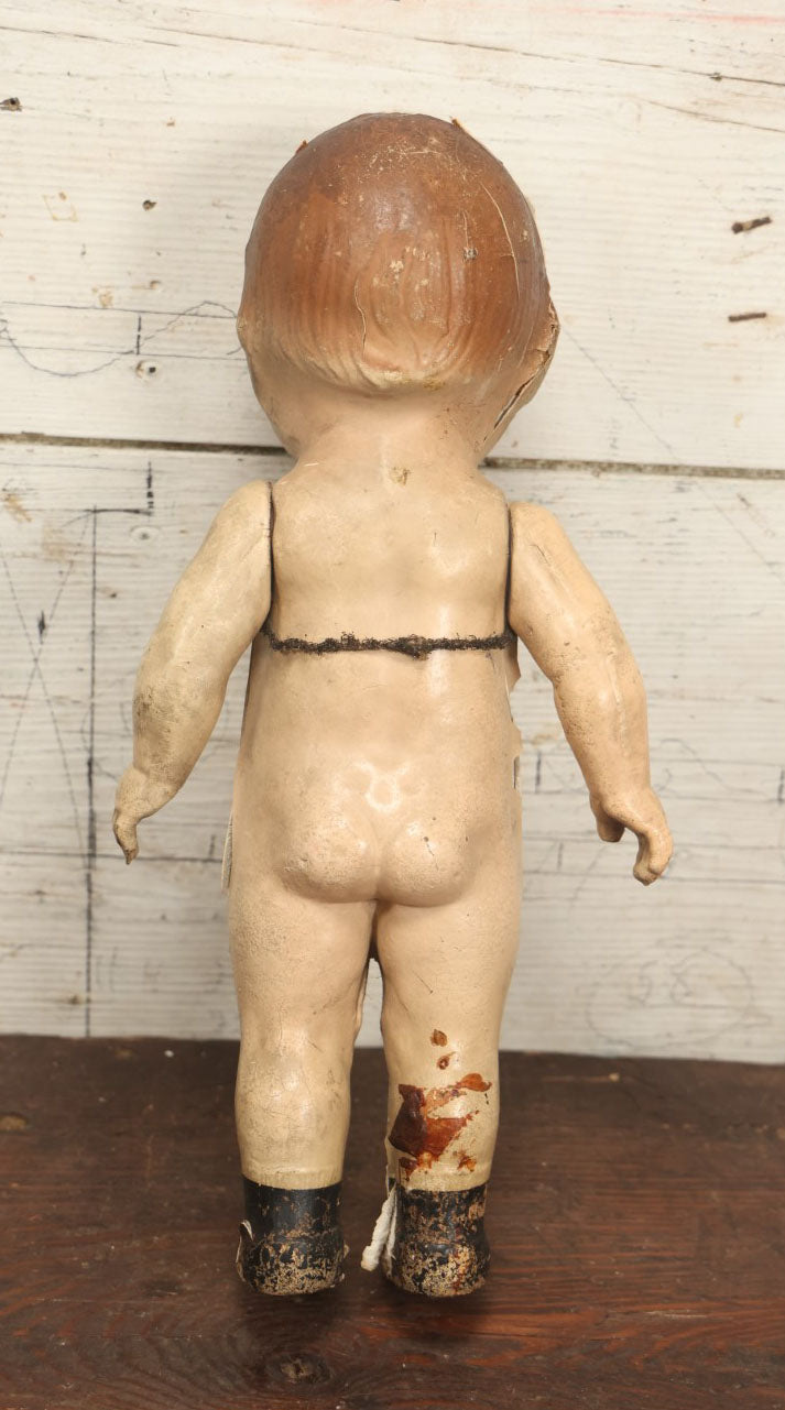 Lot 038 - Antique Composition Kewpie Like Doll With Cute Face, Painted Details, 14" Tall, Various Wear And Loss To Porcelain