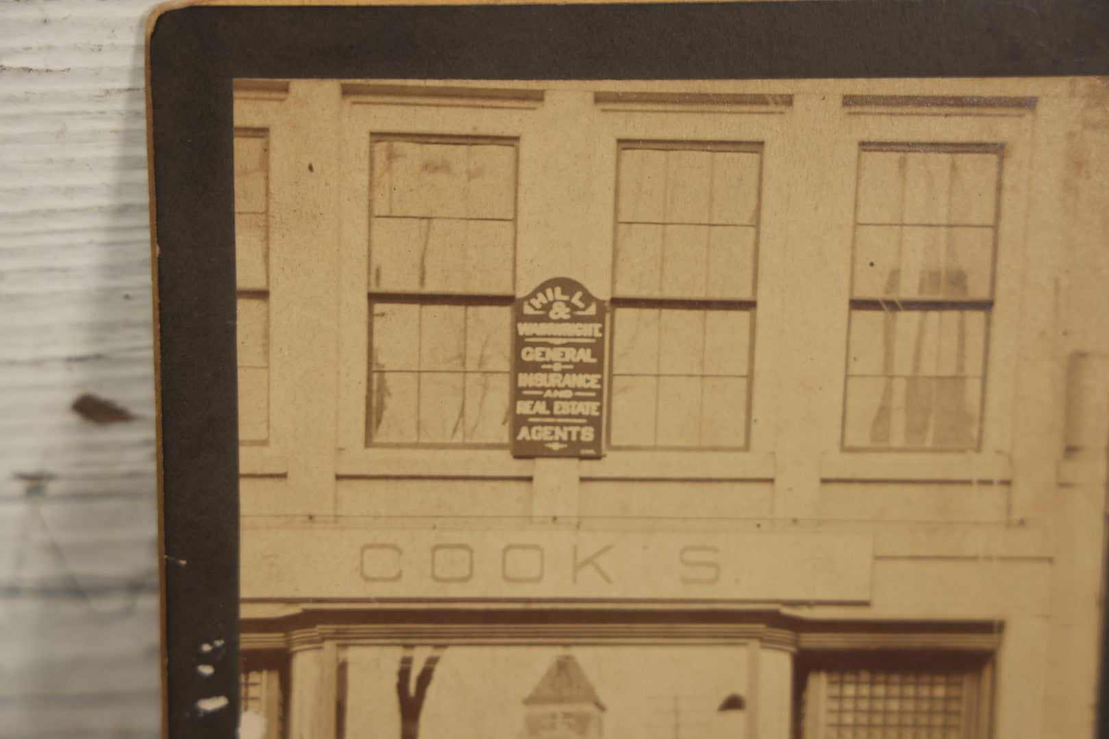 Lot 051 - Antique Cabinet Card Occupational Photograph Of Four Men Outside Of A Commercial Building Store Front, Sign Says "Cook's", Real Estate Sign, Building In Window Reflection, Men Id'd On Back