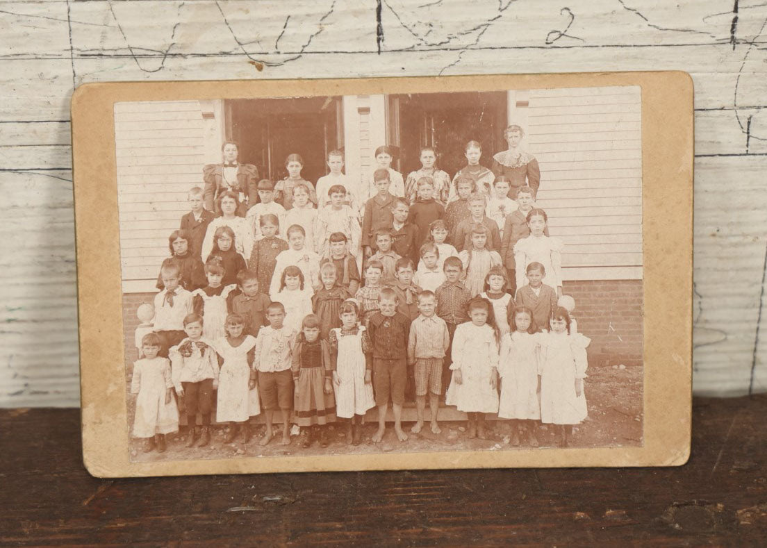 Lot 054 - Antique Cabinet Card Photograph Of A School Class Of Young Children, Boys And Girls, With Two Women Teachers, Standing On Steps, Note Many Barefoot Children, By A.W. & G.E. Howes, Photographers, Ashfield, Massachusetts]