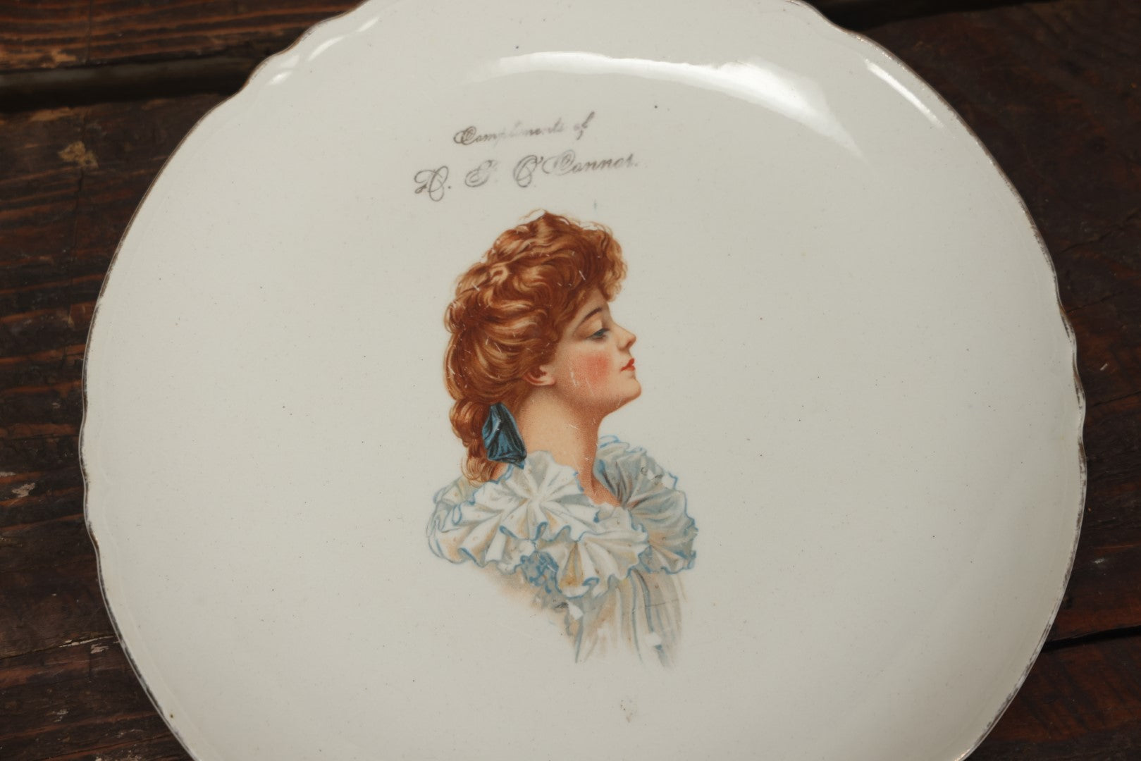 Lot 060 - Antique Porcelain Transferware Advertising Plate, Compliments Of D.F. O'Connor, With Woman In Profile, G.P. Co Globe China