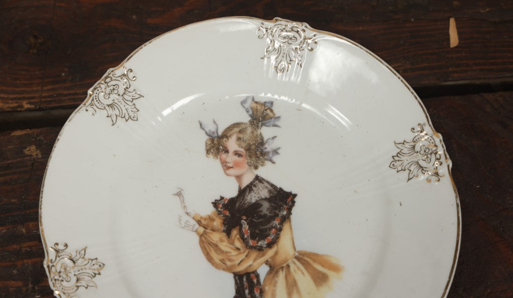 Lot 061 - Antique Porcelain Transferware Plate, With Woman In Yellow Dress, Black Shawl, Funky Hair, White Gloves