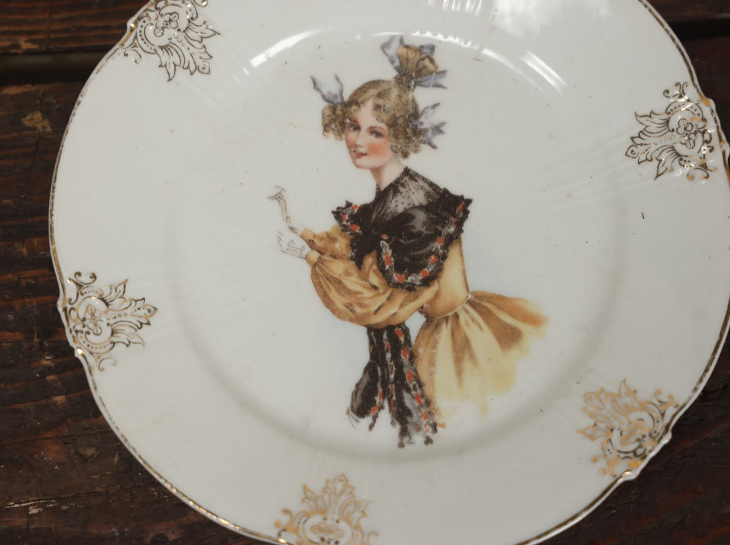 Lot 061 - Antique Porcelain Transferware Plate, With Woman In Yellow Dress, Black Shawl, Funky Hair, White Gloves