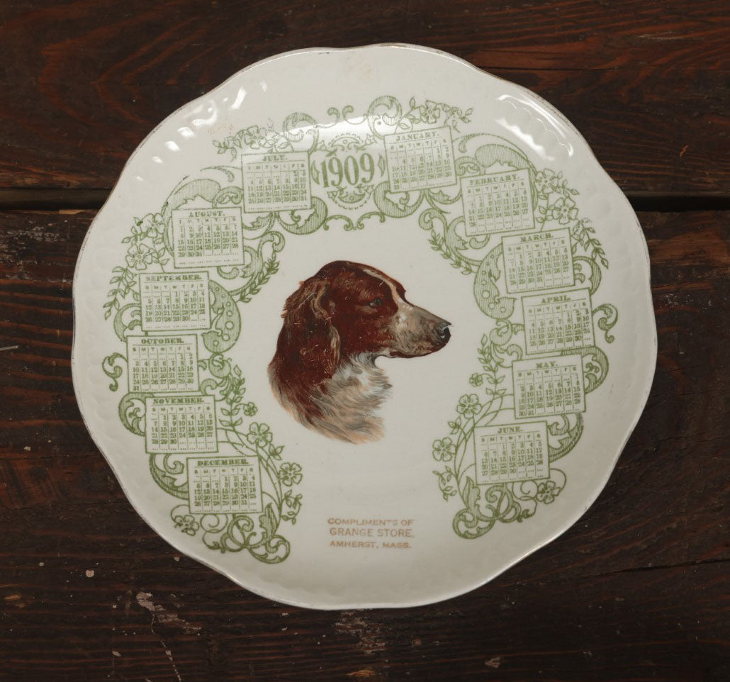 Lot 063 - Antique Porcelain Transferware 1909 Calendar Plate, With Dog, Compliments Of Grange Store, Amherst, Massachusetts, M.C. Co., E.L.O. Markings On Back