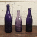 Lot 076 - Grouping Of Three Antique Deep Purple Colored Glass Bottles, Crystal Bottling Works, Tampa, Florida, Lewis Groulding, Whitman, Massachusetts, And Thomas Thimblin, Southbridge, Massachusetts