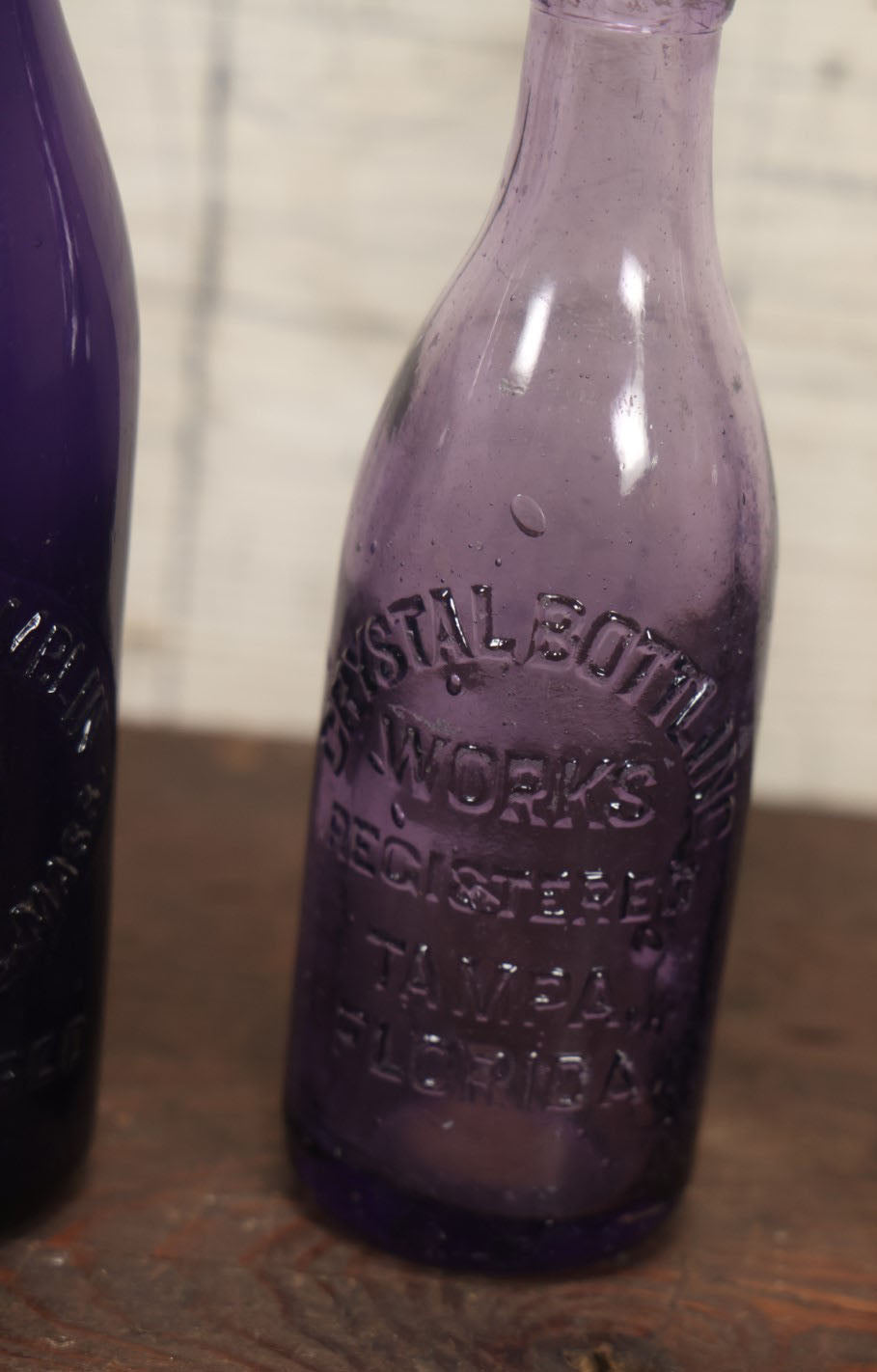 Lot 076 - Grouping Of Three Antique Deep Purple Colored Glass Bottles, Crystal Bottling Works, Tampa, Florida, Lewis Groulding, Whitman, Massachusetts, And Thomas Thimblin, Southbridge, Massachusetts