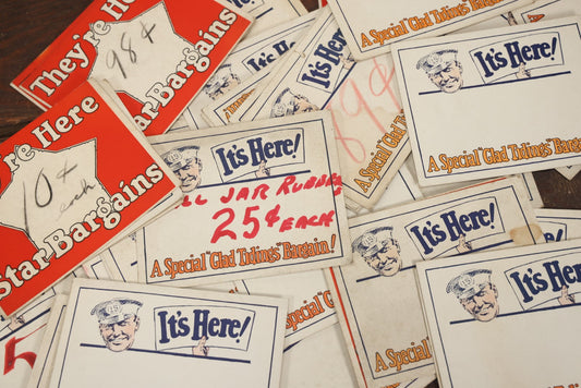 Lot 106 - Grouping Of 35 Larger Vintage Five And Dime Store Pricing Labels, "It's Here!", "A Special 'Glad Tidings' Bargain!" And More, With Man In Cap Mascot, Approximately 7" x 5-1/2"