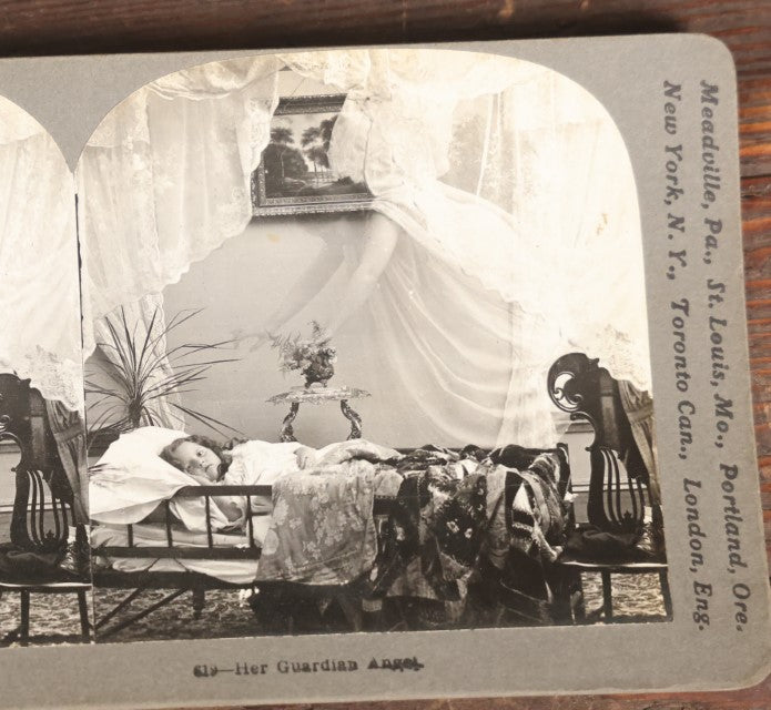 Lot 127 - Antique Spirit Photograph Stereo Card, "Her Guardian Angel" Featuring Ghostly Angel Over Sleeping Child, By Keystone View Company, Copyright 1898