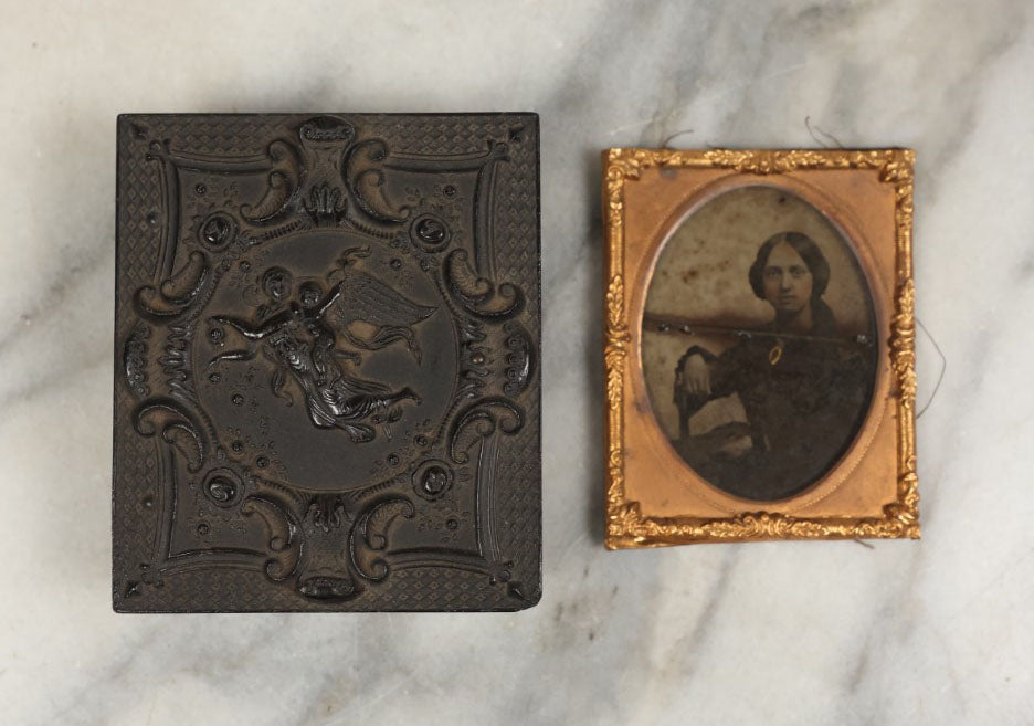 Lot 001 - Antique Union Case Thermoplastic Gutta Percha 1/9th Plate Hard Image Case With Angel And Baby, By S. Peck And Co., Manufacturers, With Damaged Ambrotype Of Woman