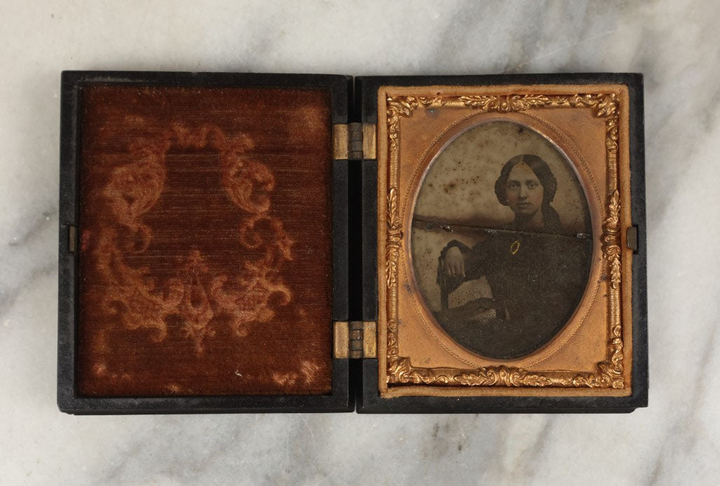 Lot 001 - Antique Union Case Thermoplastic Gutta Percha 1/9th Plate Hard Image Case With Angel And Baby, By S. Peck And Co., Manufacturers, With Damaged Ambrotype Of Woman