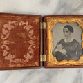 Lot 003 - Antique 1/6th Plate Ambrotype Of Woman With Sleeping Baby In Her Arms, Gold Painted Jewelry On Image, In Thermoplastic Case