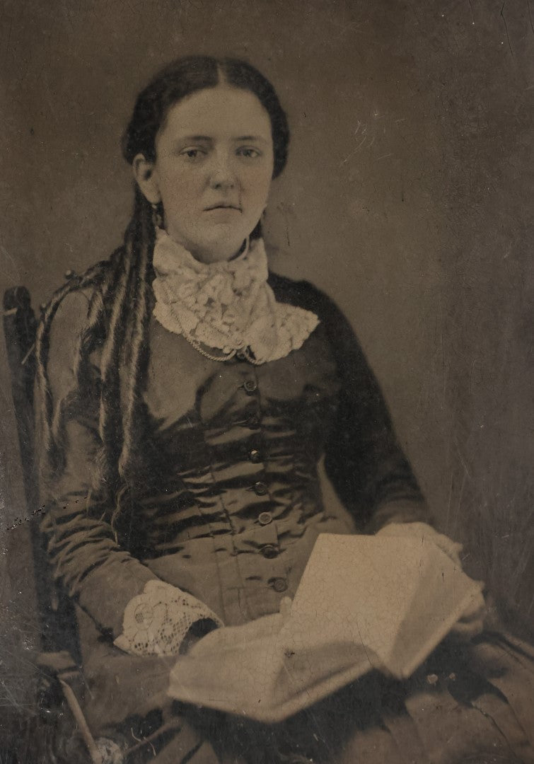 Lot 004 - Antique 1/2 Plate Tintype Photograph Of A Young Woman With An Open Book In Her Lap, Long Curls In Her Hair