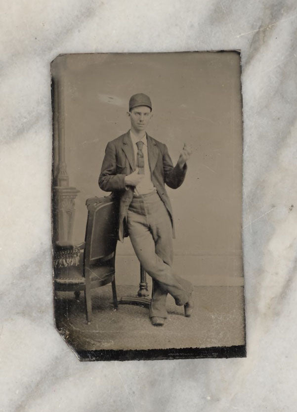 Lot 008 - Antique Tintype Photo Of A Young Man In A Cap, Short Tie, Making Hand Gesture