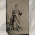 Lot 008 - Antique Tintype Photo Of A Young Man In A Cap, Short Tie, Making Hand Gesture