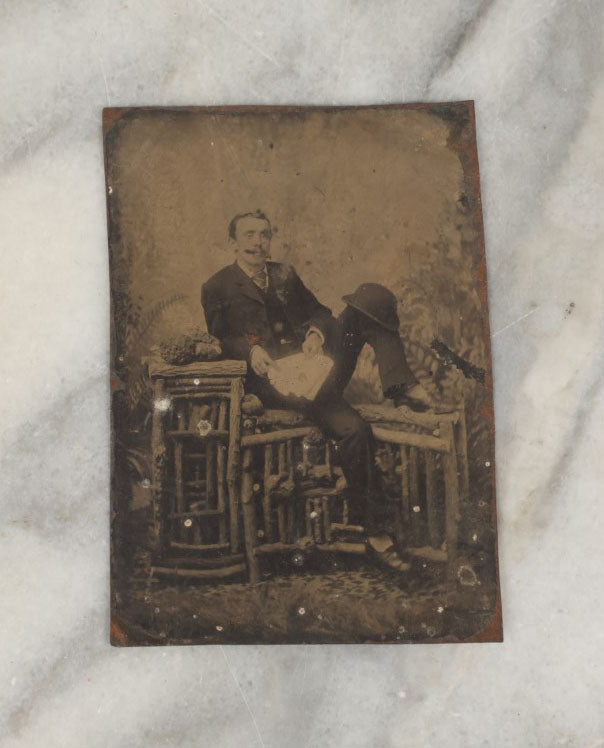 Lot 009 - Antique Tintype Photo Of A Man Casually Posing With Leg Up, Cigar In Mouth, Bowler Hat On Knee