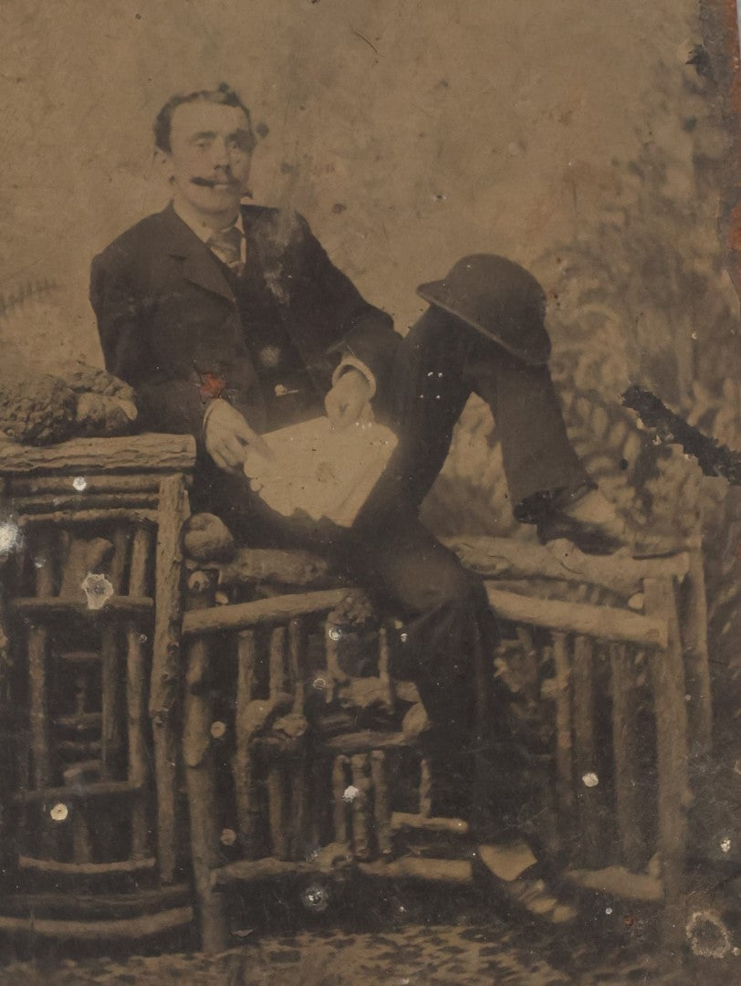 Lot 009 - Antique Tintype Photo Of A Man Casually Posing With Leg Up, Cigar In Mouth, Bowler Hat On Knee