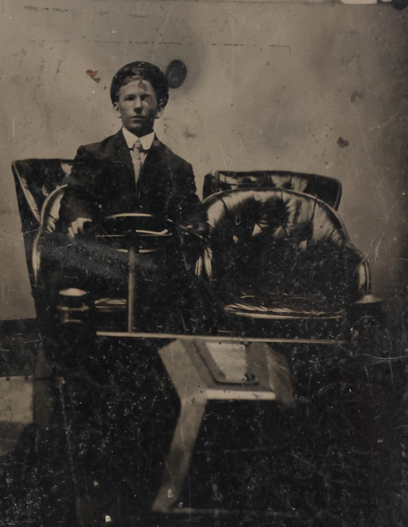 Lot 012 - Antique Tintype Photo Of A Man In An Early Automobile, Holding Steering Wheel, Tufted Leather Seats