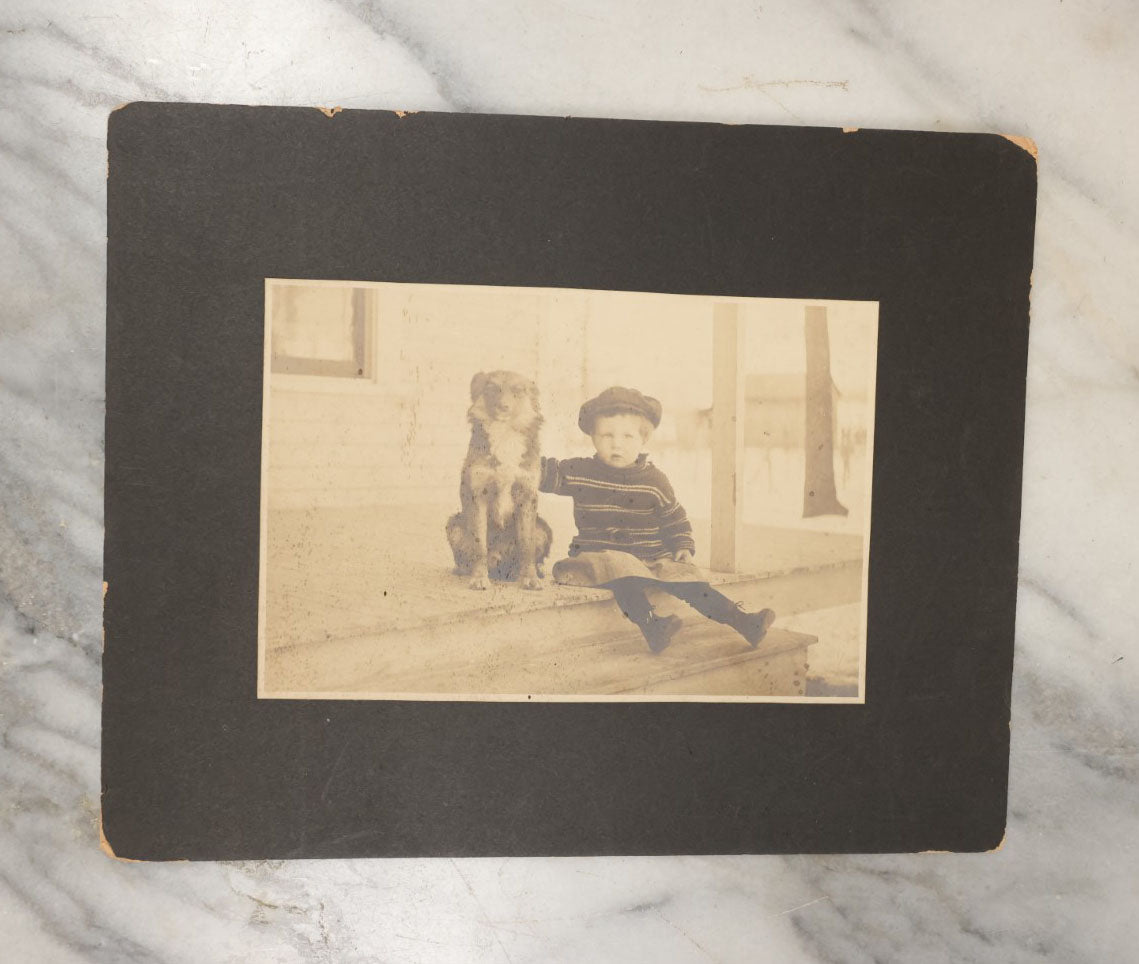 Lot 017 - Antique Boarded Photograph Of A Young Boy In A Hat Sitting On The Front Porch Stoop With His Dog, Identified As Floyd Clement, Jr.