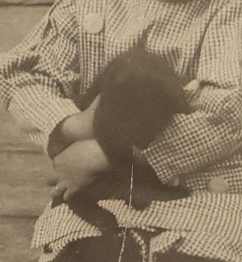 Lot 018 - Antique Boarded Photograph Of A Young Boy In A Hat Sitting On The Front Porch Stoop With A Small Black Cat In His Arms, Cat Moving, Blurry