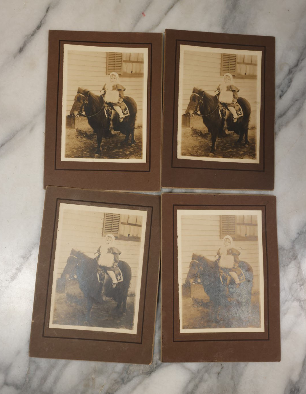 Lot 021 - Grouping Of Four Identical Vintage Boarded Photographs Of A Toddler Riding On The Back Of A Long-Haired Pony 