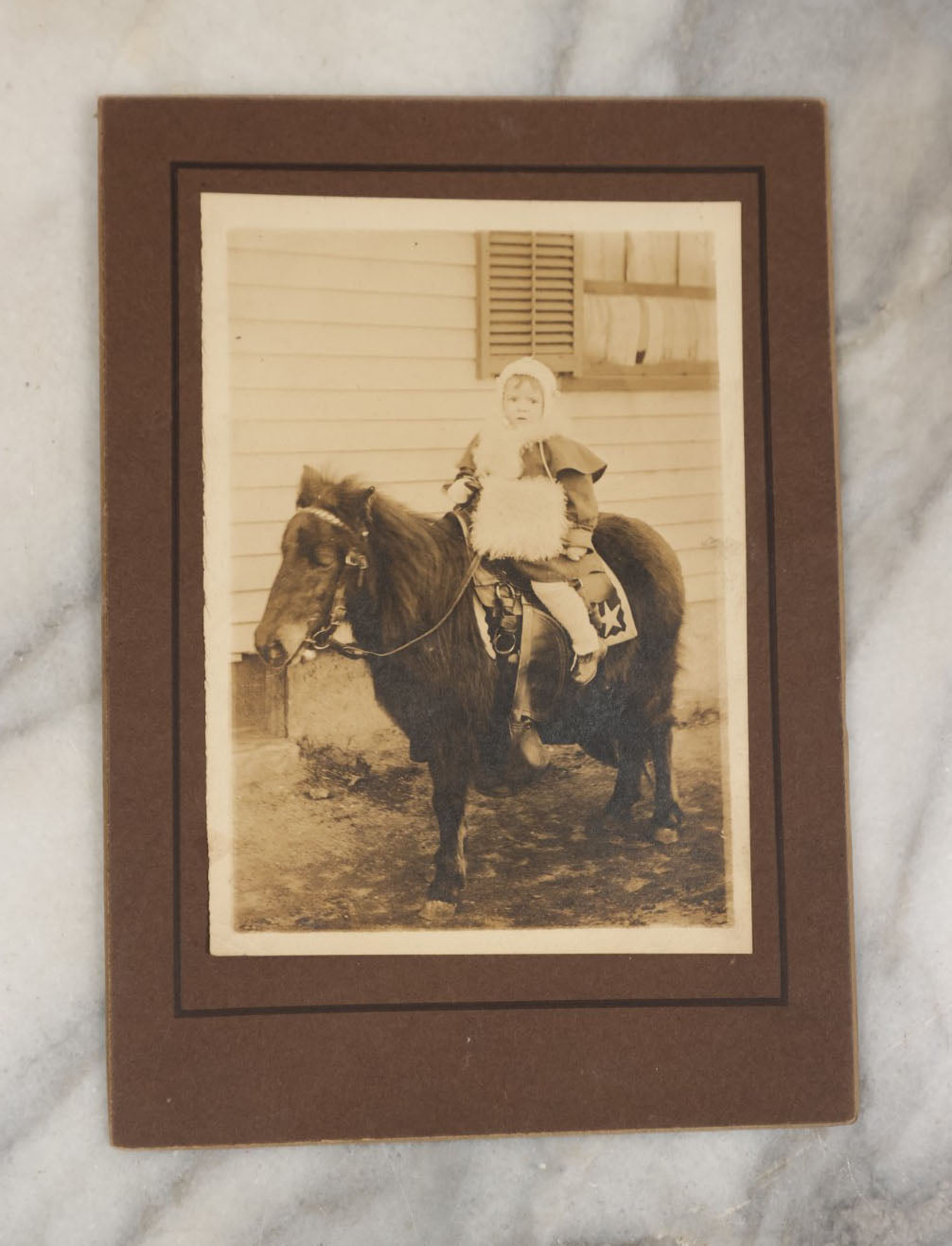 Lot 021 - Grouping Of Four Identical Vintage Boarded Photographs Of A Toddler Riding On The Back Of A Long-Haired Pony 