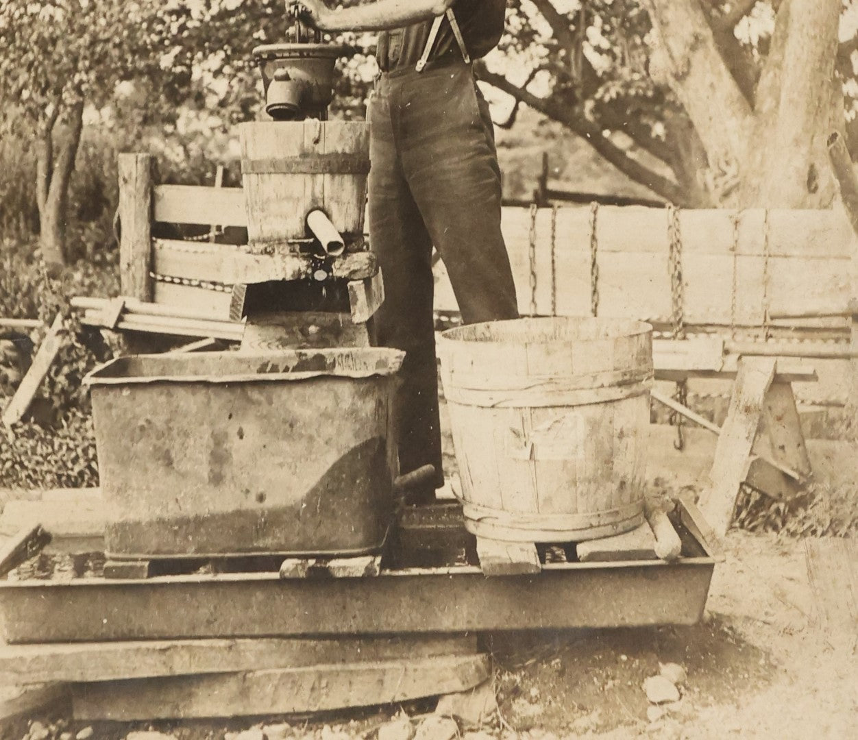 Lot 022 - Antique Boarded Occupational Photograph Of A Man Preparing A Beverage With A Press, Possible Moonshine Or Wine Making